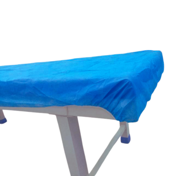 Non-woven disposable bedsheet fitted on a medical examination couch.