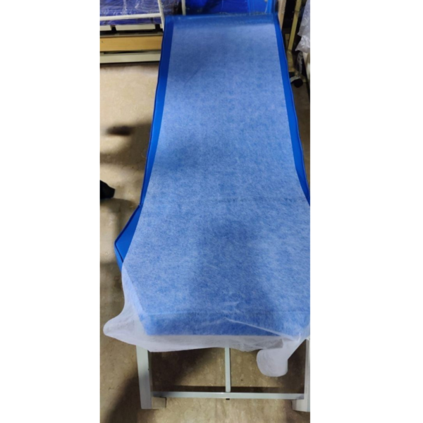 20 GSM white non-woven disposable medical couch sheet on an examination couch.